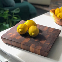 Load image into Gallery viewer, Arbor Novo Black Walnut Modern Chopping Board on Counter with Lemons.
